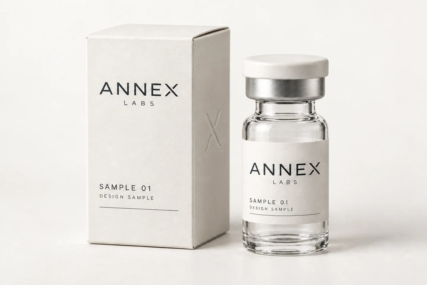 The Annex carton and vial packaging concept, in warm white with a subtle embossed X